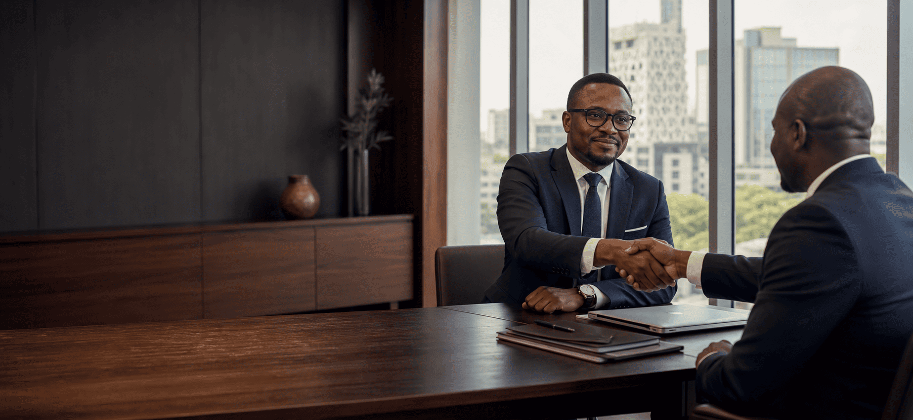 Lawyer shaking hands with a client in a modern office