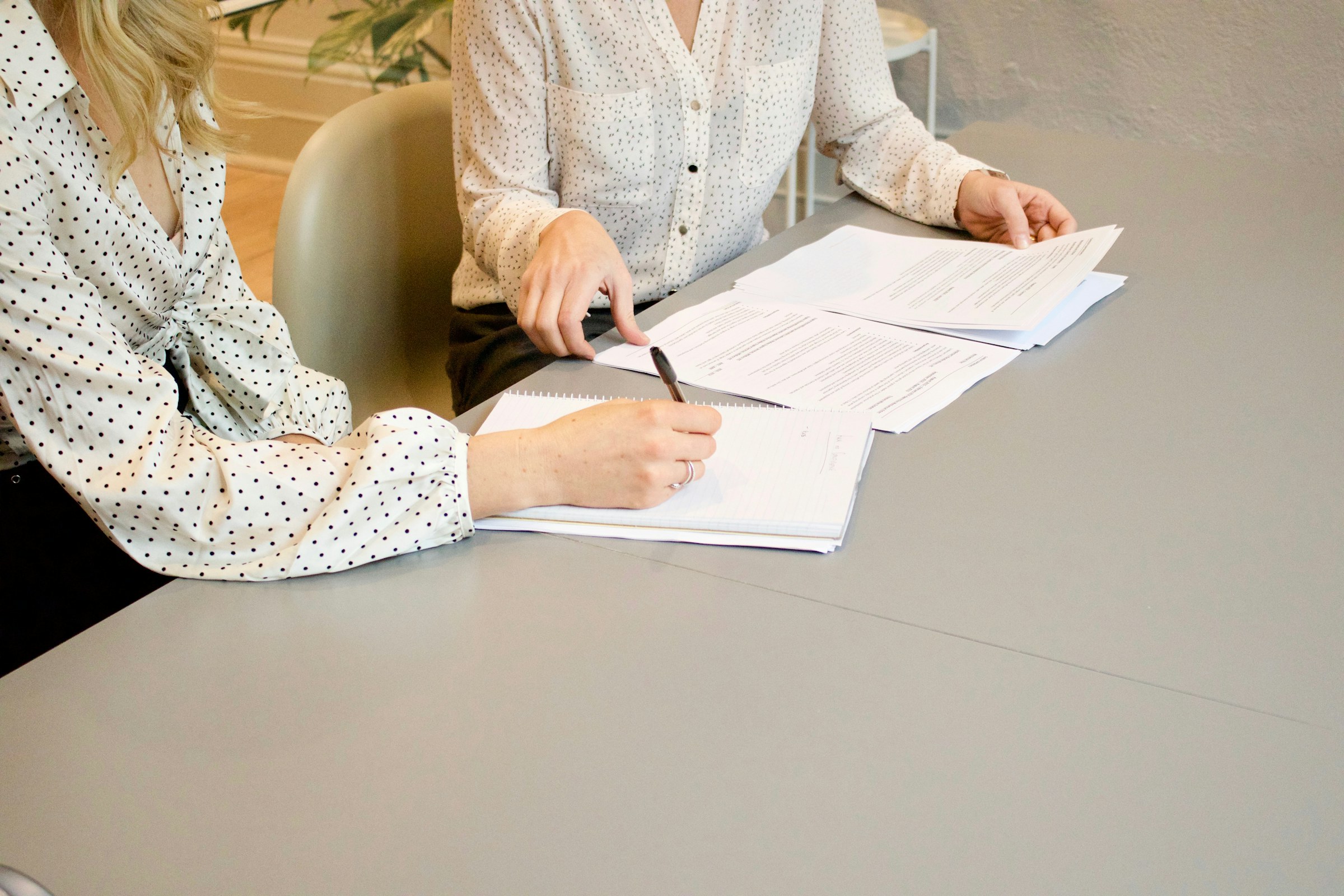 Professionals reviewing workplace documents together