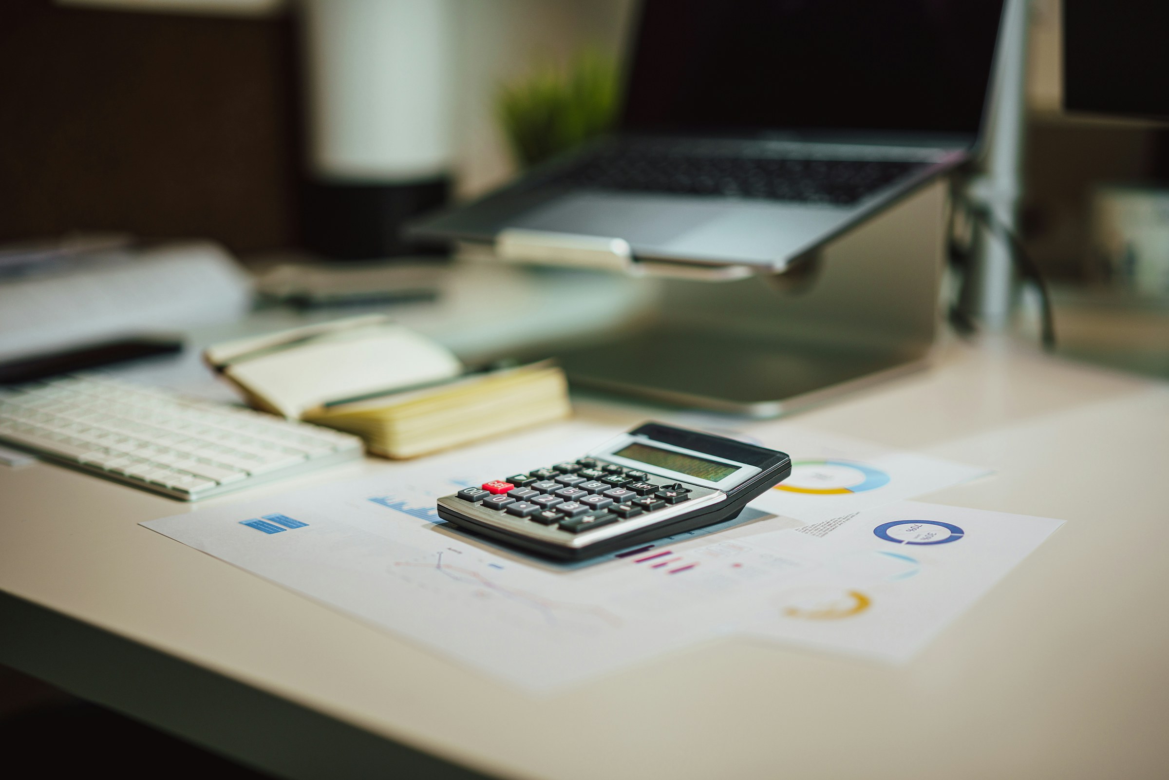 Calculator and financial reports on an office desk